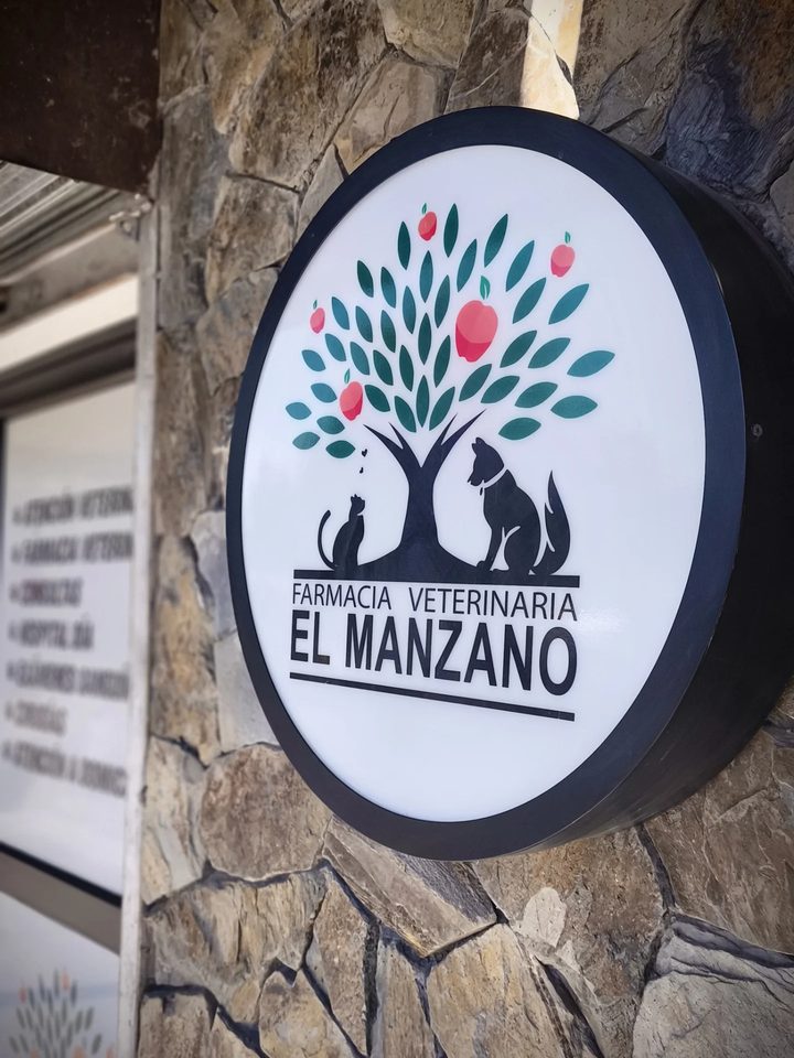El letrero redondo de la veterinaria, con el manzano del logo